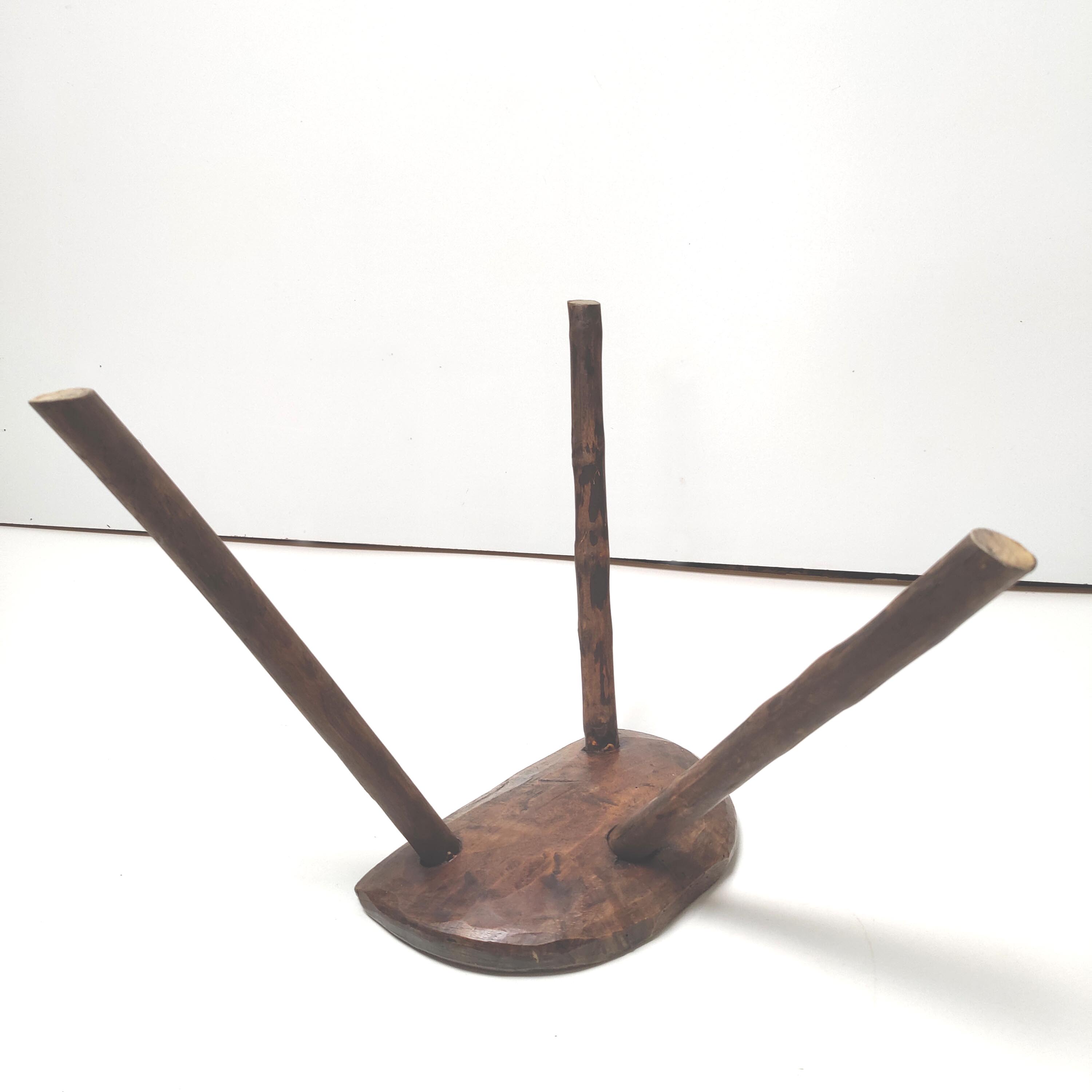 Brutalist tripod stool in solid wood half round
