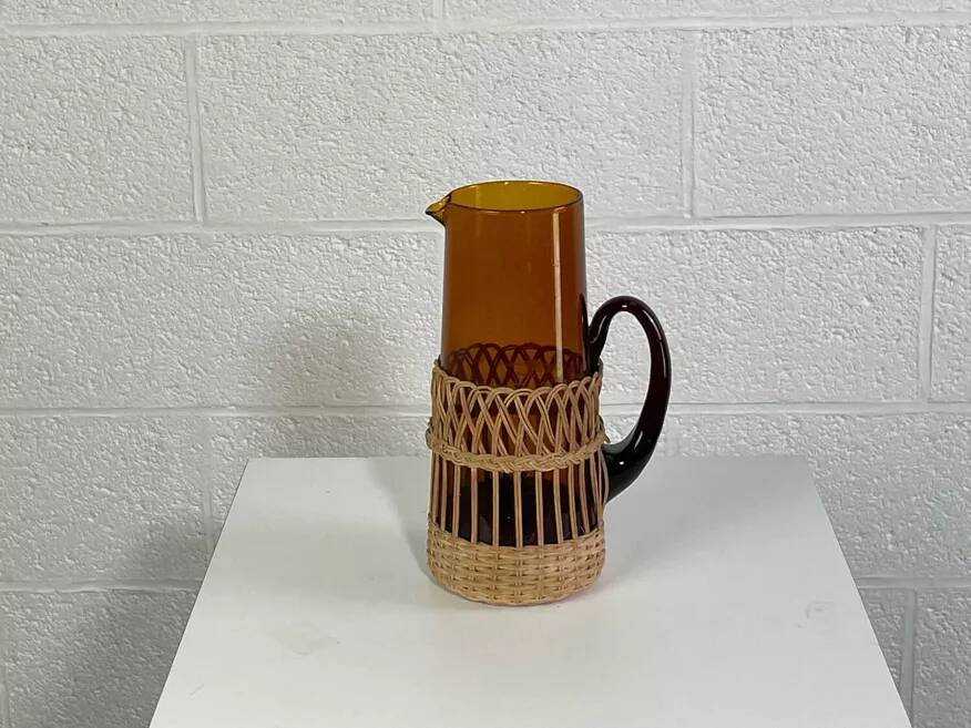 Vintage service for orangeade in amber glass and wicker.