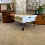 Coffee table with pin legs and gold leaf