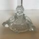 Thick moulded glass candlestick with fish and flowers.