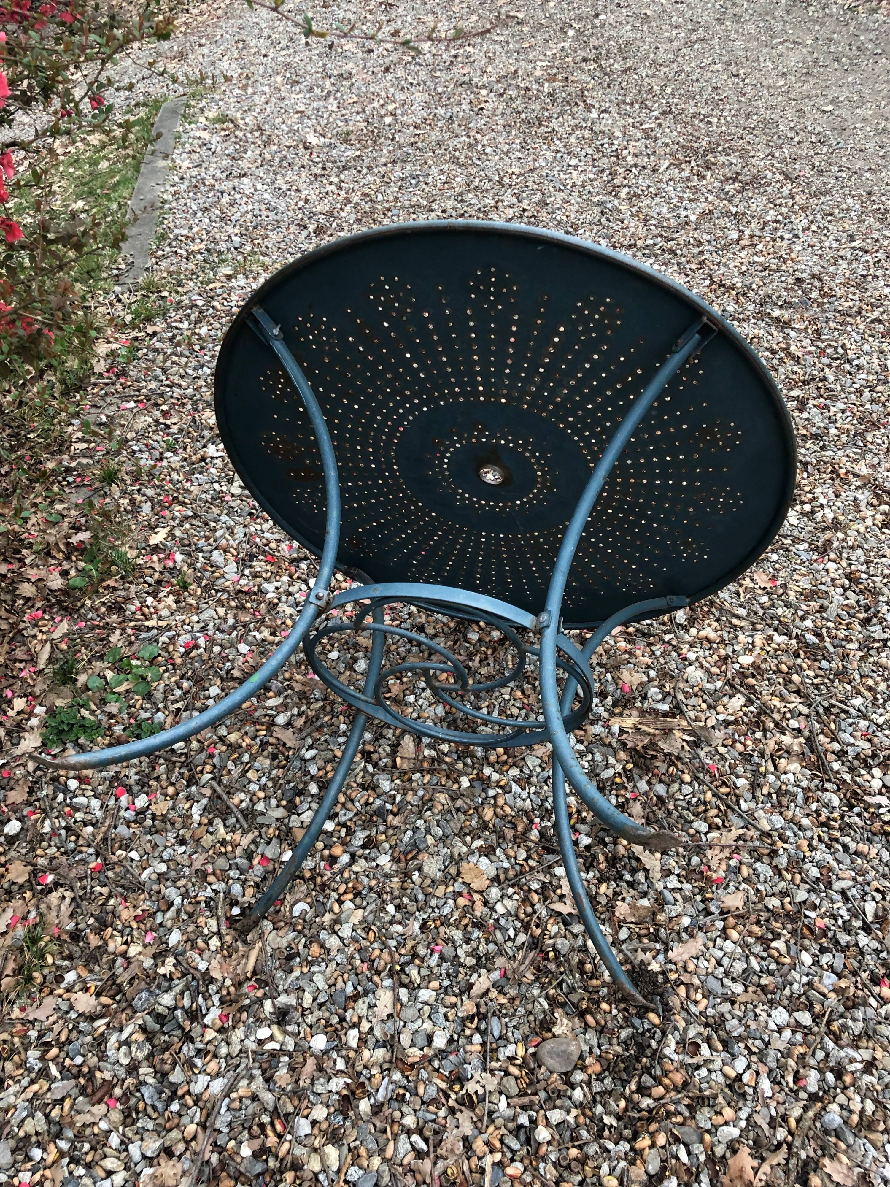 Green wrought-iron garden table round