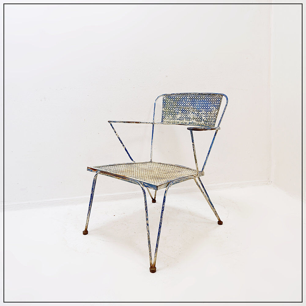 Vintage perforated metal armchair from the 1950s.