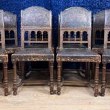 Set of 8 Renaissance style chairs in walnut and embossed leather