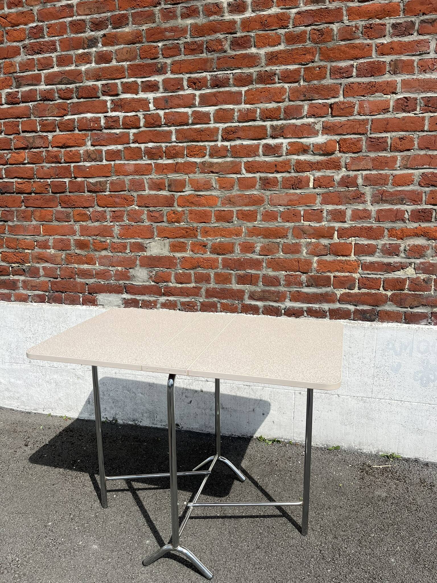 Folding table with chrome and pink formica.
