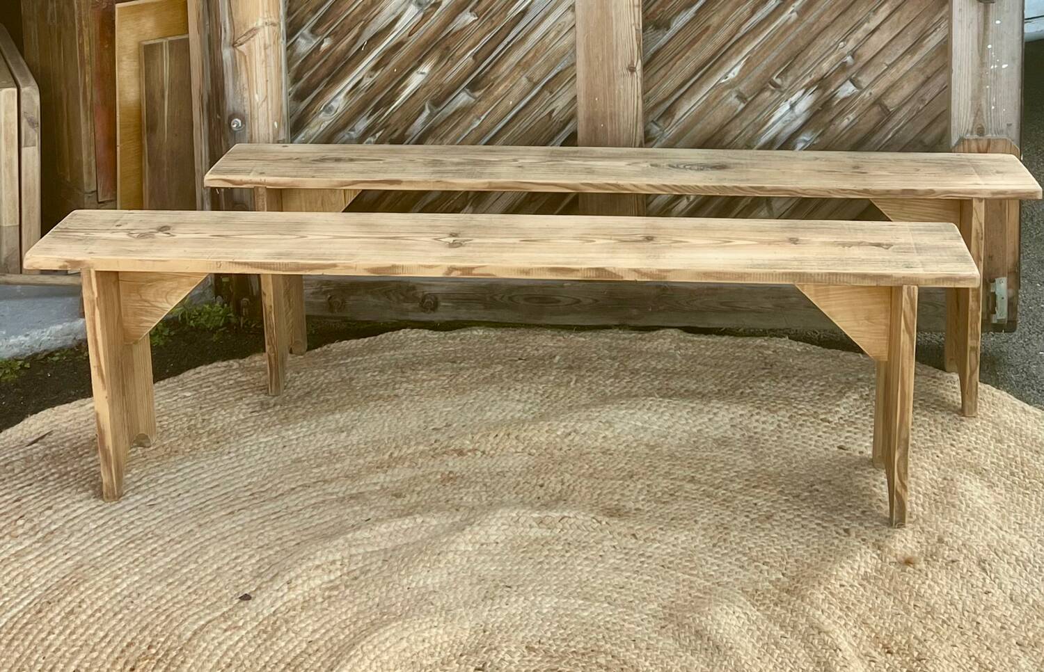 Pair of old farmhouse benches made of raw solid wood.
