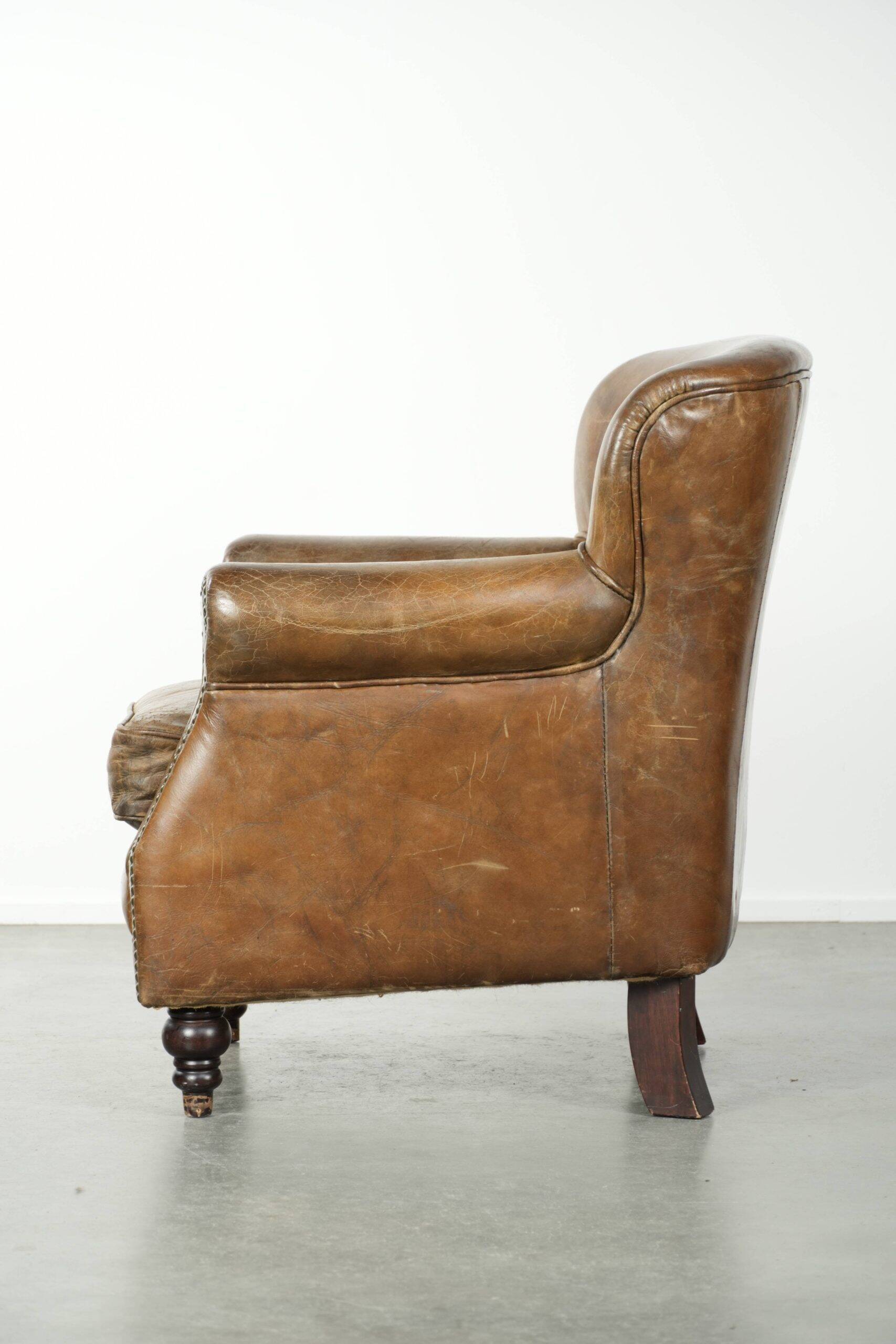 Robust cowhide armchair in a beautifully subtle size with a wonderful patina.