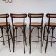 4 curved wood and cane bar stools