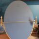 Oval mirror patinated brass frame art deco