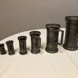 Set of 7 pots of tin measures