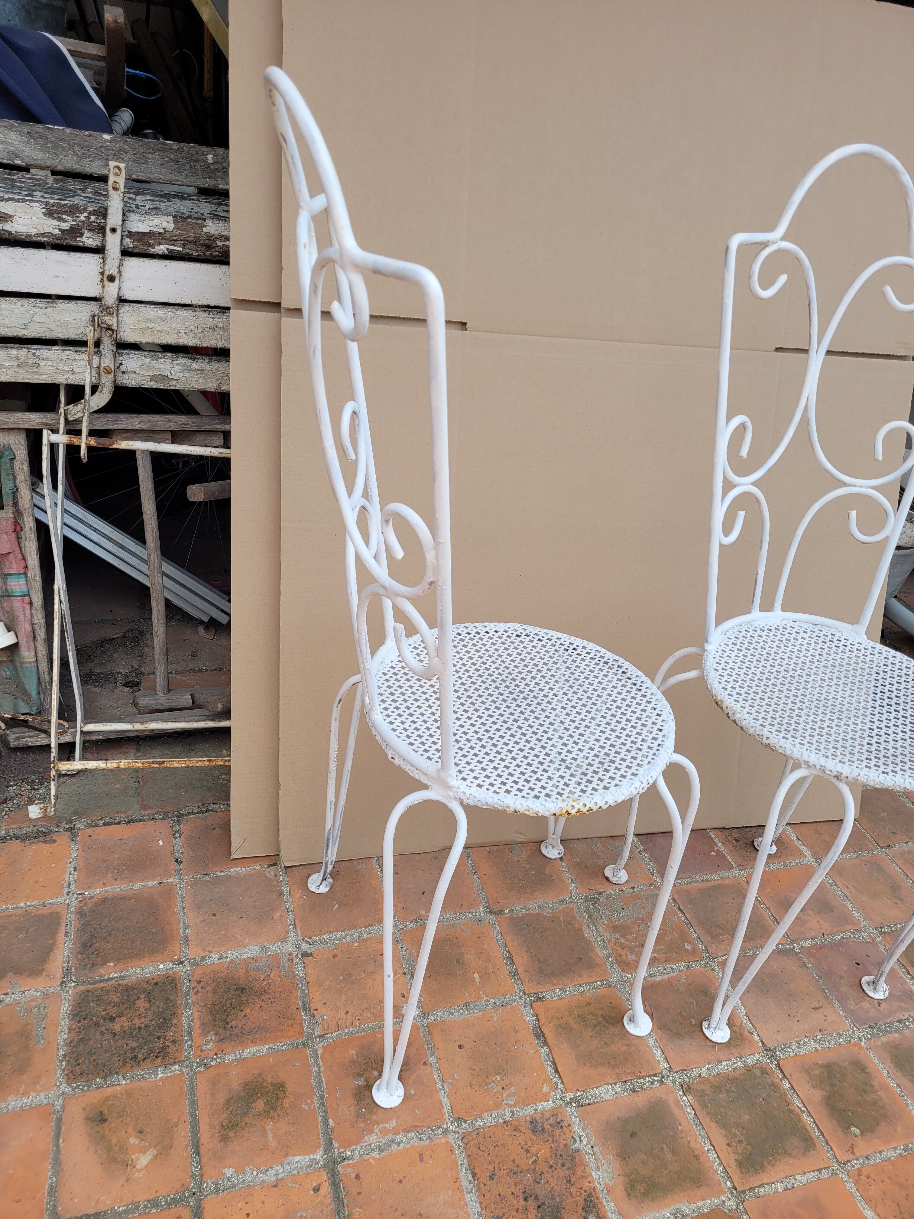 Pair of antique wrought iron garden chairs