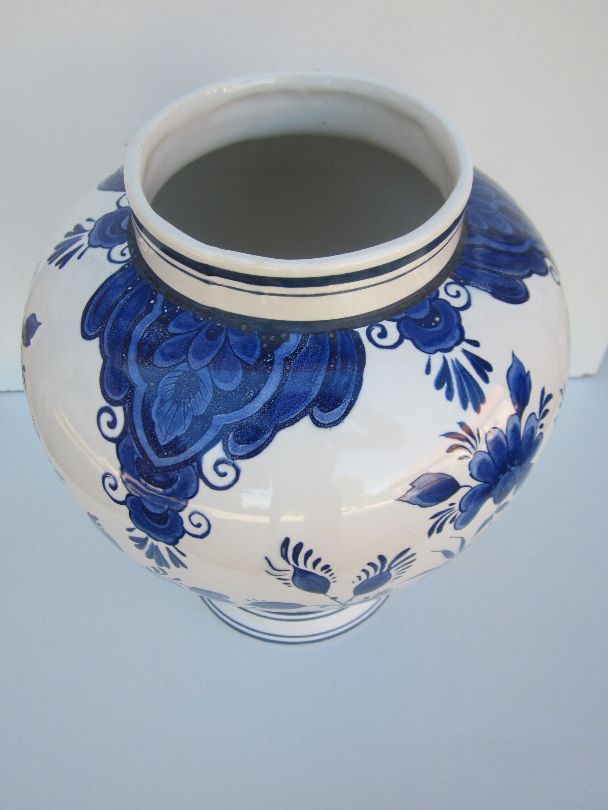 Ceramic vase earthenware, blue floral decoration on a white background