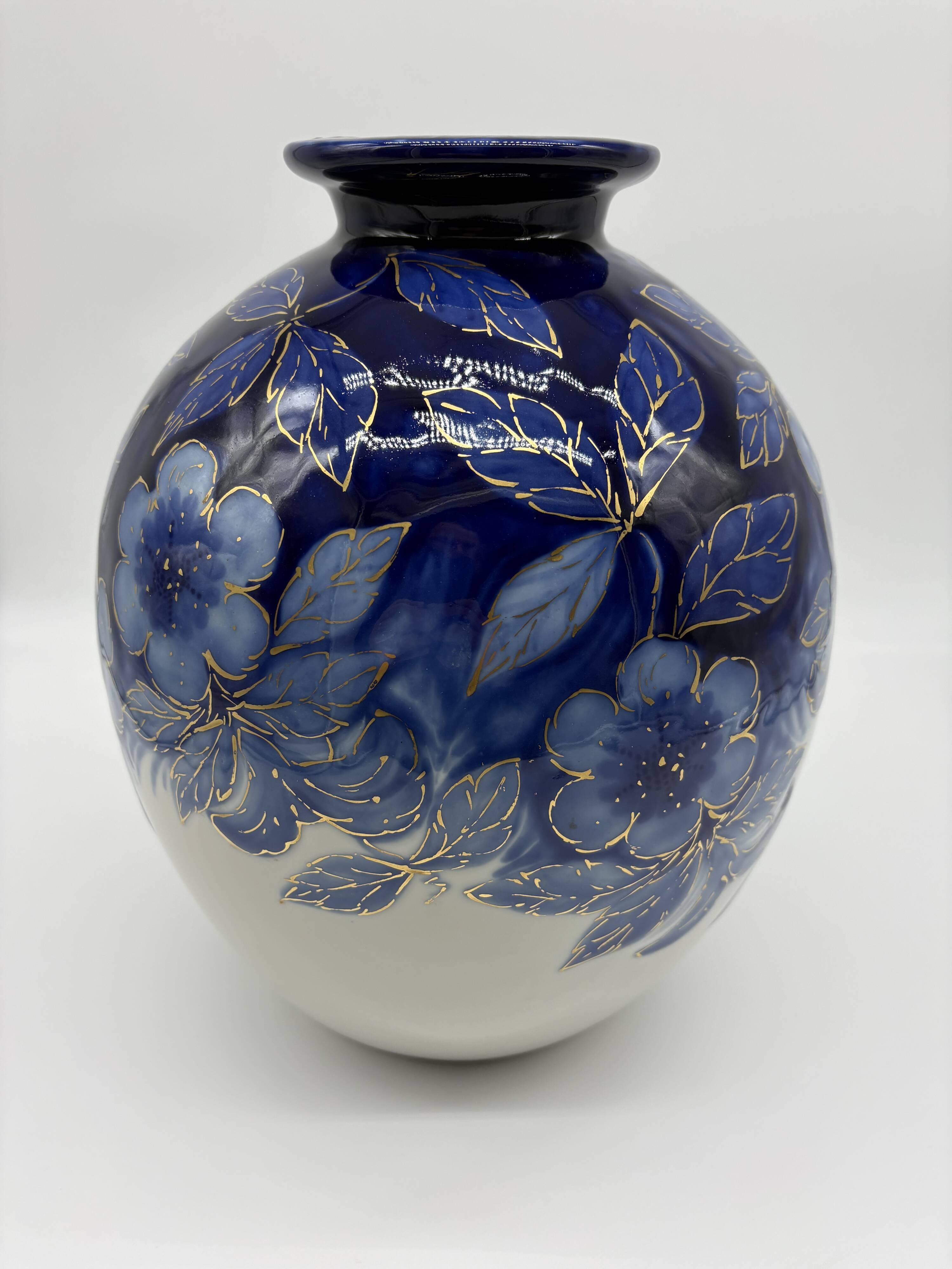 Large Tharaud Limoges vase in cobalt blue porcelain with floral decoration.