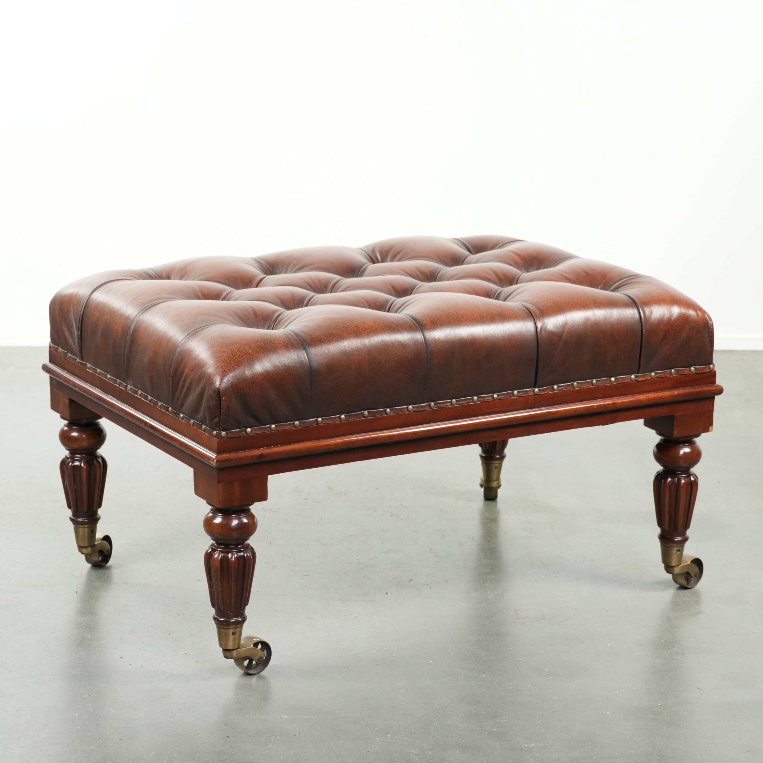 Brown cowhide Chesterfield ottoman in English style with ornate legs