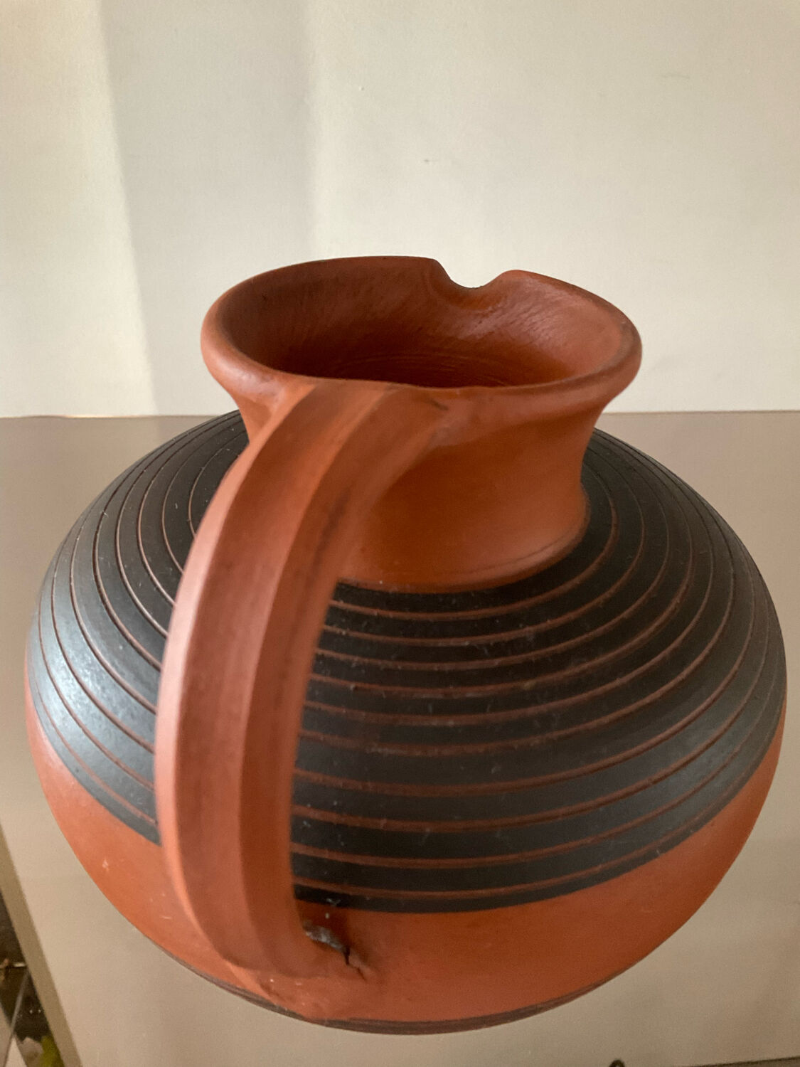 Vintage jug in chiseled terracotta