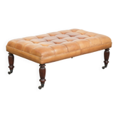 Sheepskin ottoman/coffee table on wheels in English chesterfield style