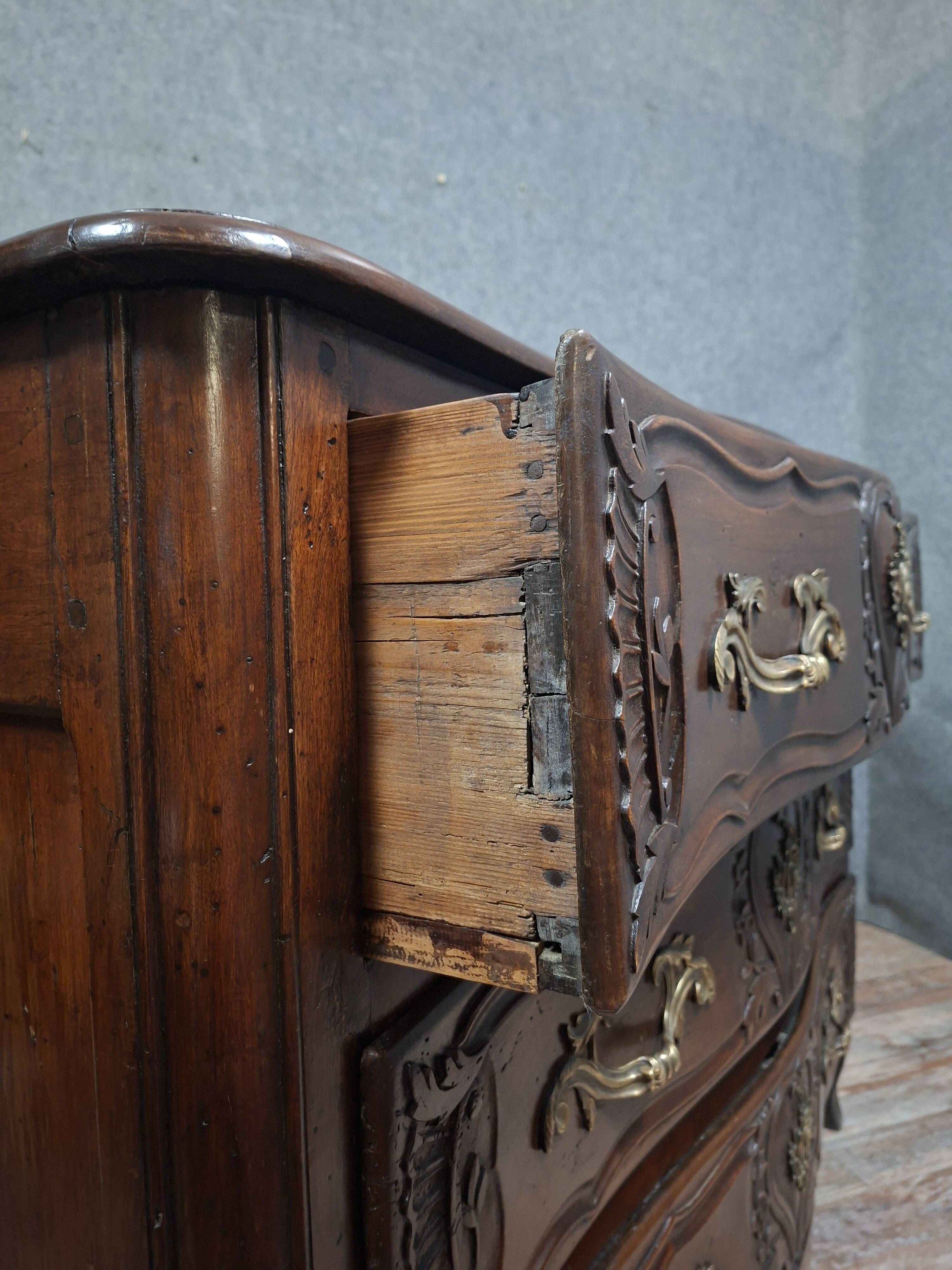 Louis XV/XVIII period Lyonnaise commode in moulded and carved walnut.