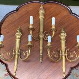 Set of three Empire-style candlesticks.