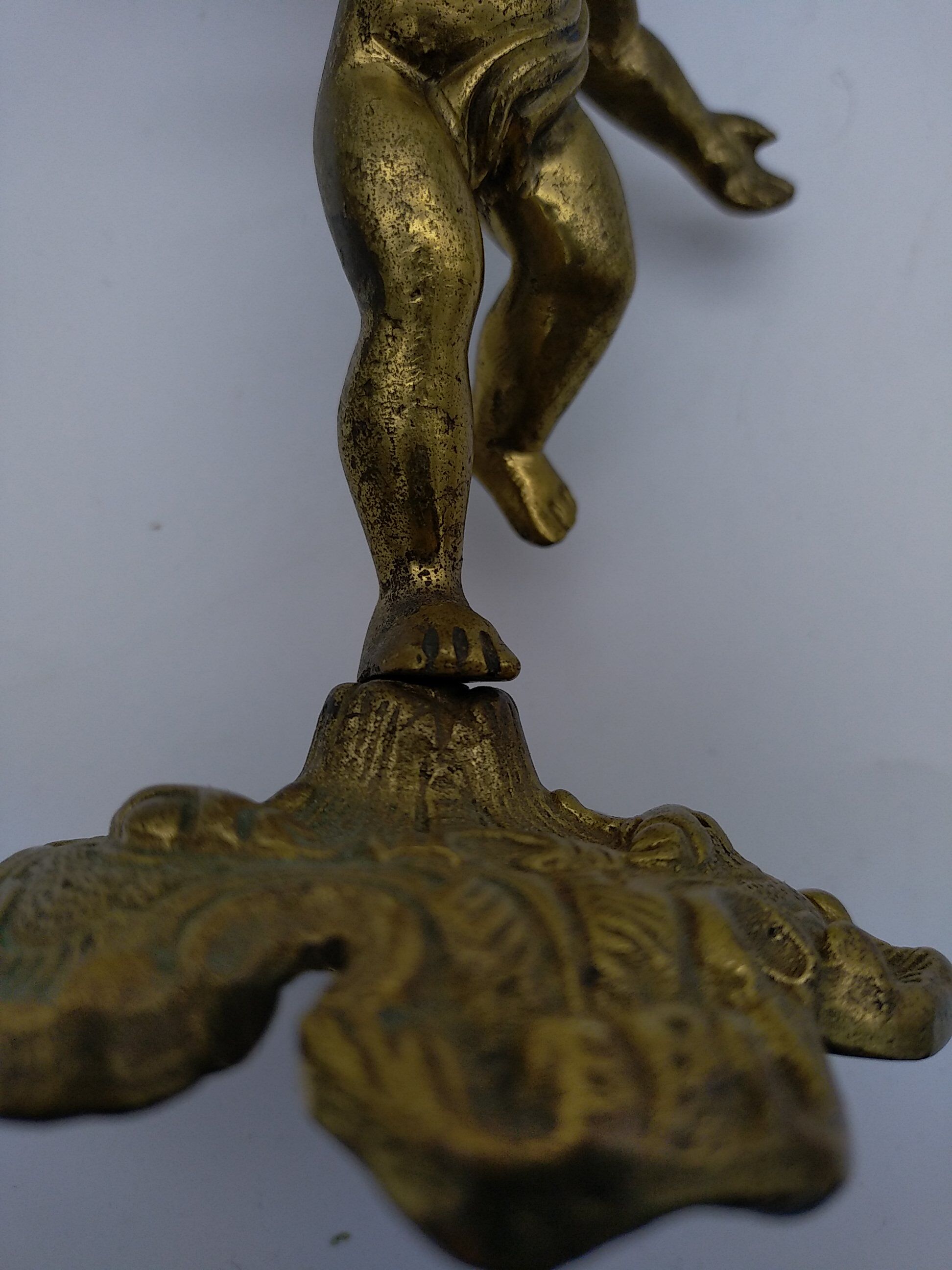 Cherub or putti carrying a globe