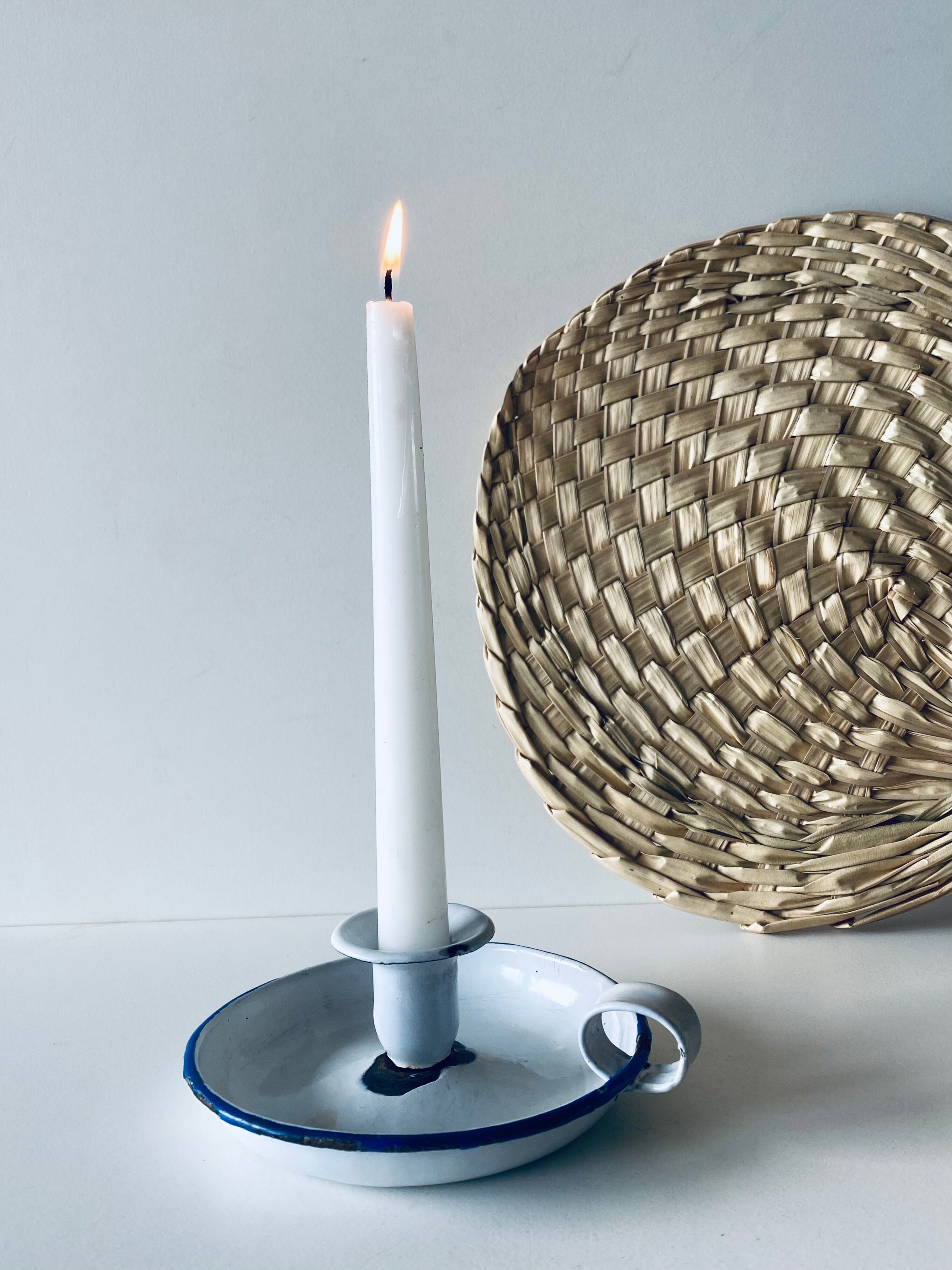 Old enamelled metal candlestick