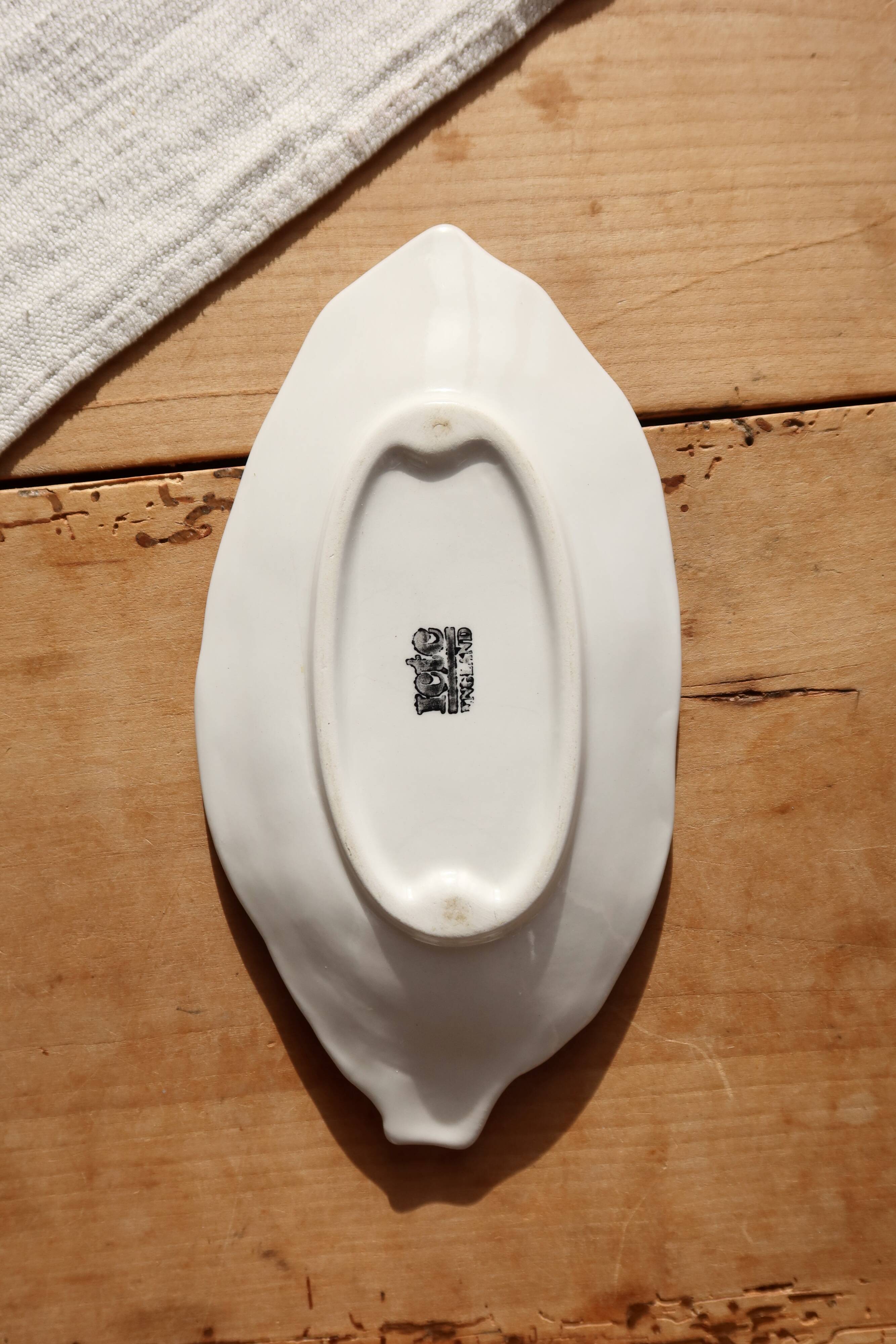 Antique leaf-shaped white English slipware dish.