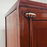 Antique red cabinet with brass details