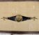 Old armrest ashtray with fleur-de-lis design in leather and brass.