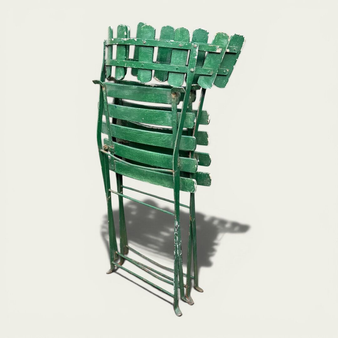 Pair of original patinated folding Parisian bistro chairs.