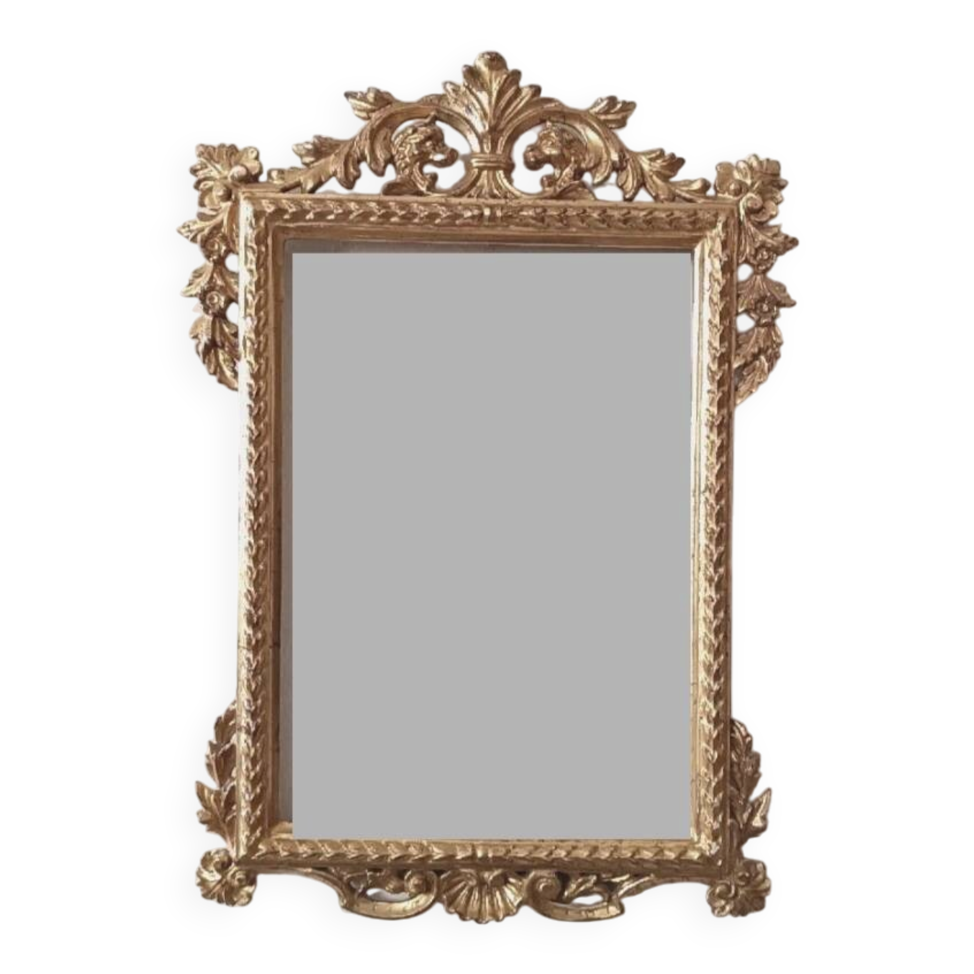 Mirror with a carved wooden frame in an antique style in pure gold.