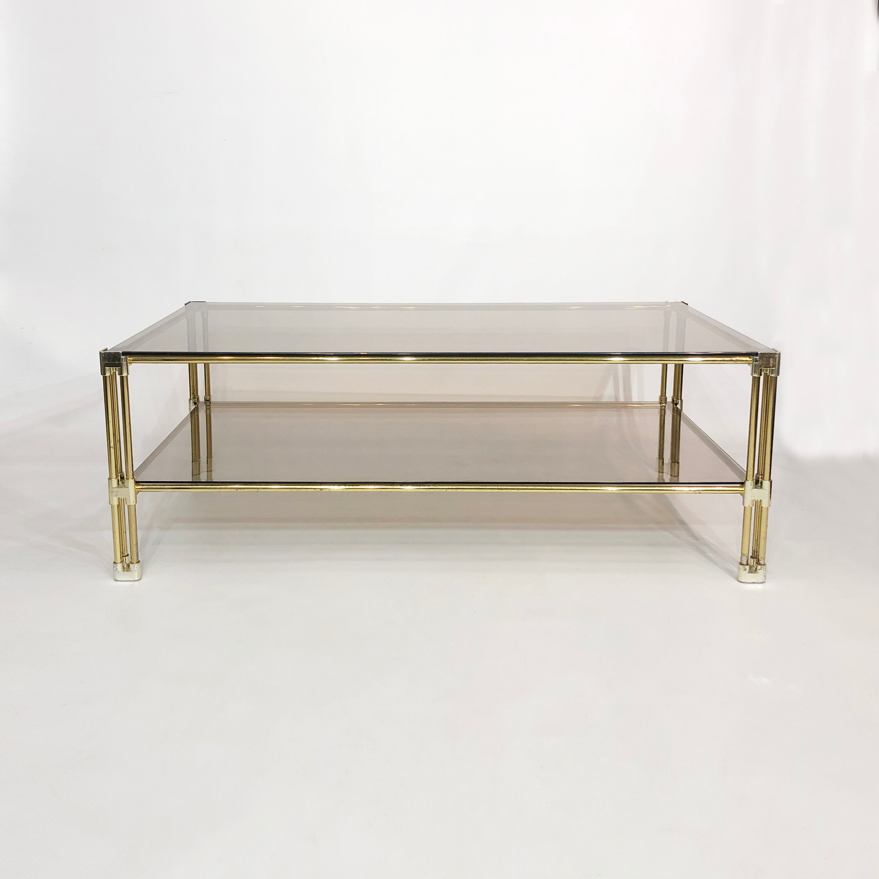 Brass two-tiered coffee table hollywood regency gold smoked glass 1970s