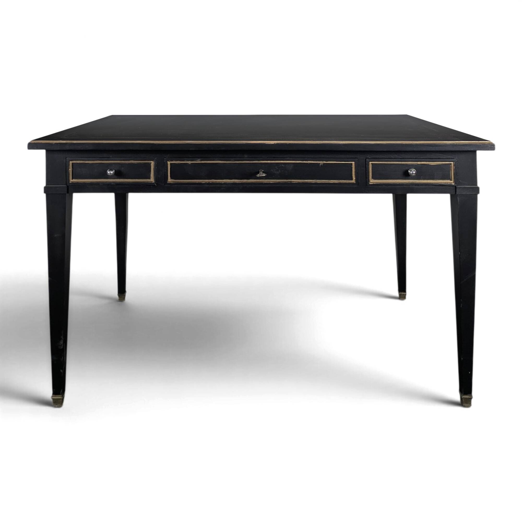 Large flat desk in Louis XVI style, black lacquered with gold highlights.