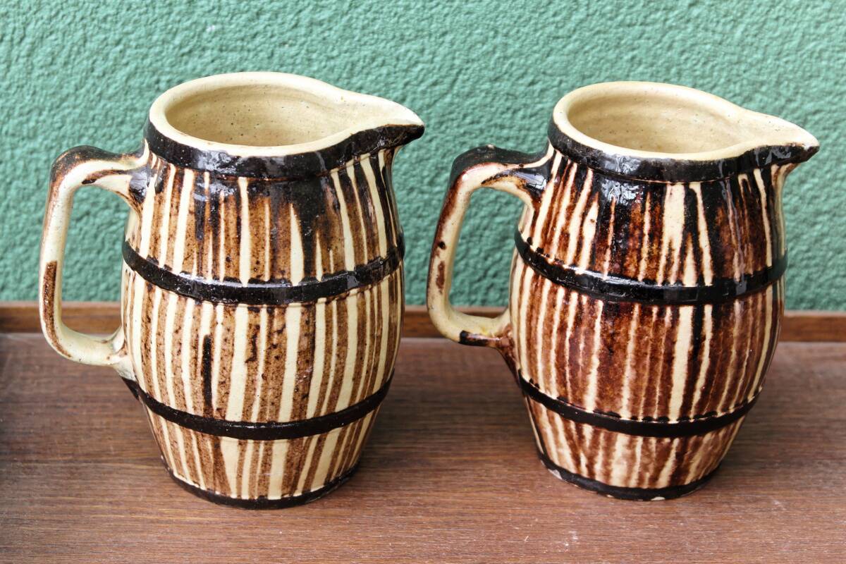 Pair of trompe l'oeil bistro pitchers, barrels