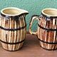 Pair of trompe l'oeil bistro pitchers, barrels