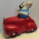 Dog toy driving his red car