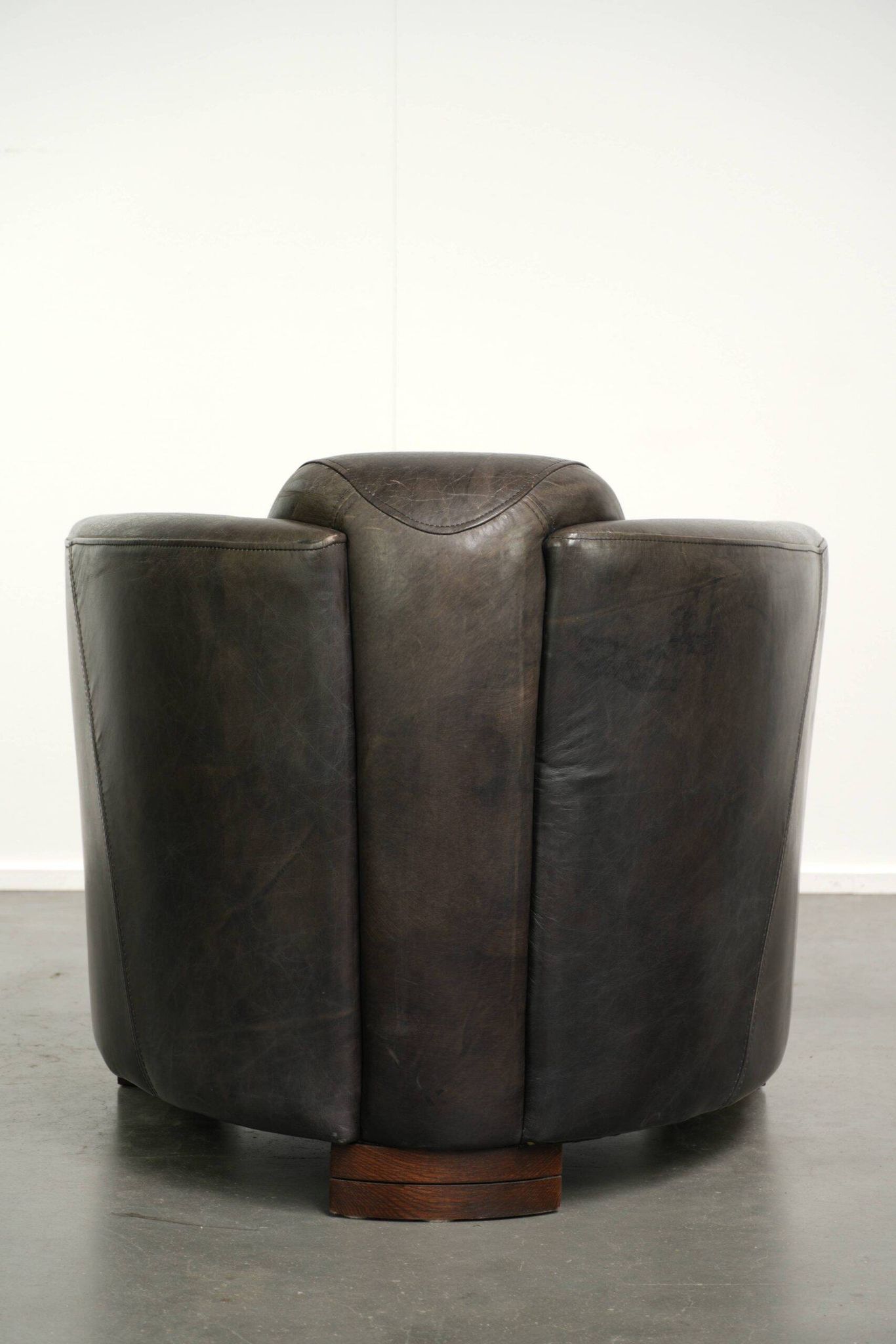 Cow leather Aviator design armchair in a dark colour scheme
