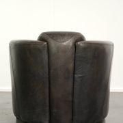Cow leather Aviator design armchair in a dark colour scheme