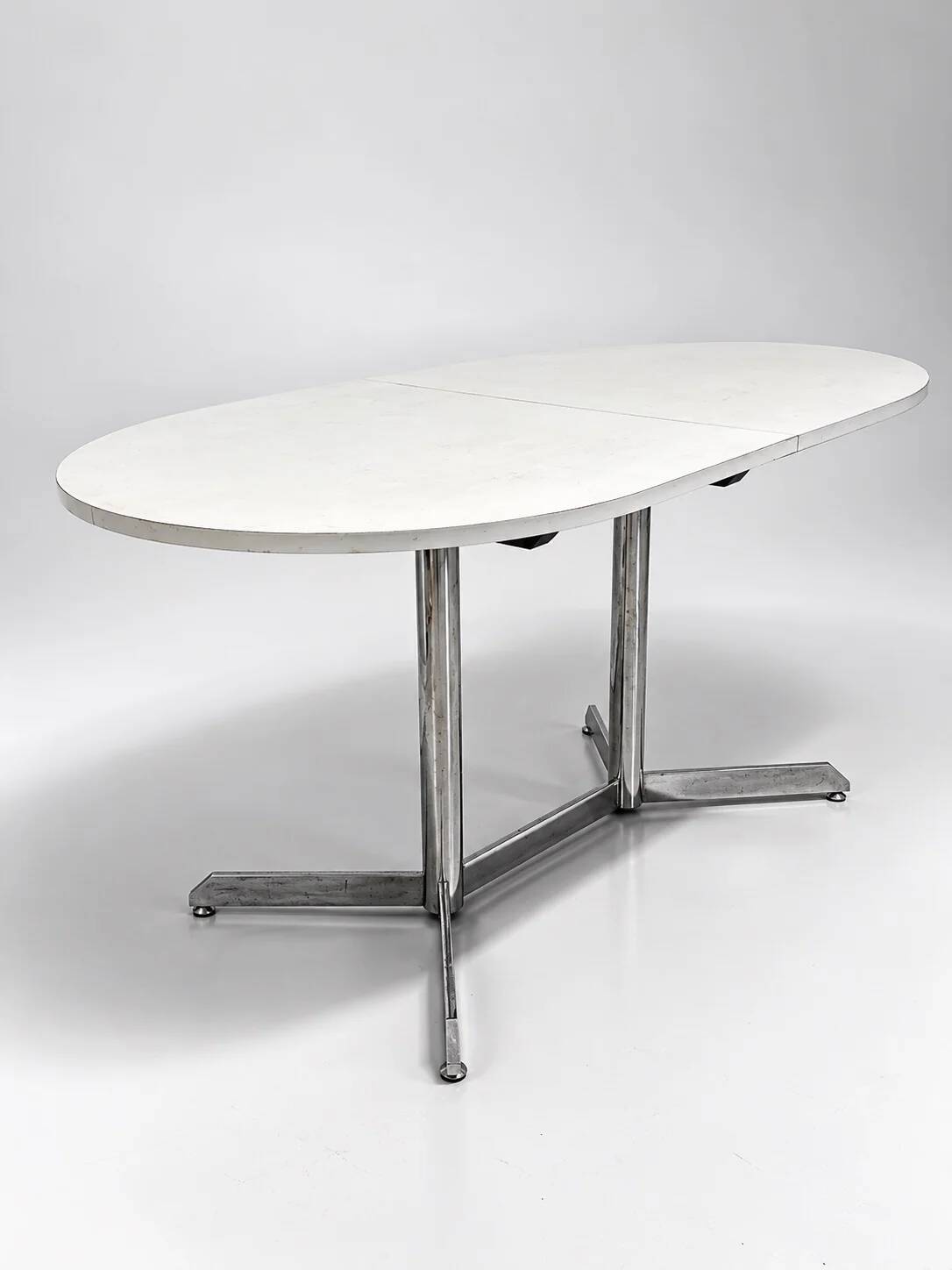 Vintage oval extendable dining table, white laminate and chrome, 1970s.