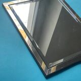 Faceted modernist wall mirror in steel and brass, geometric mixed metal frame 1970s.