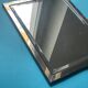 Faceted modernist wall mirror in steel and brass, geometric mixed metal frame 1970s.