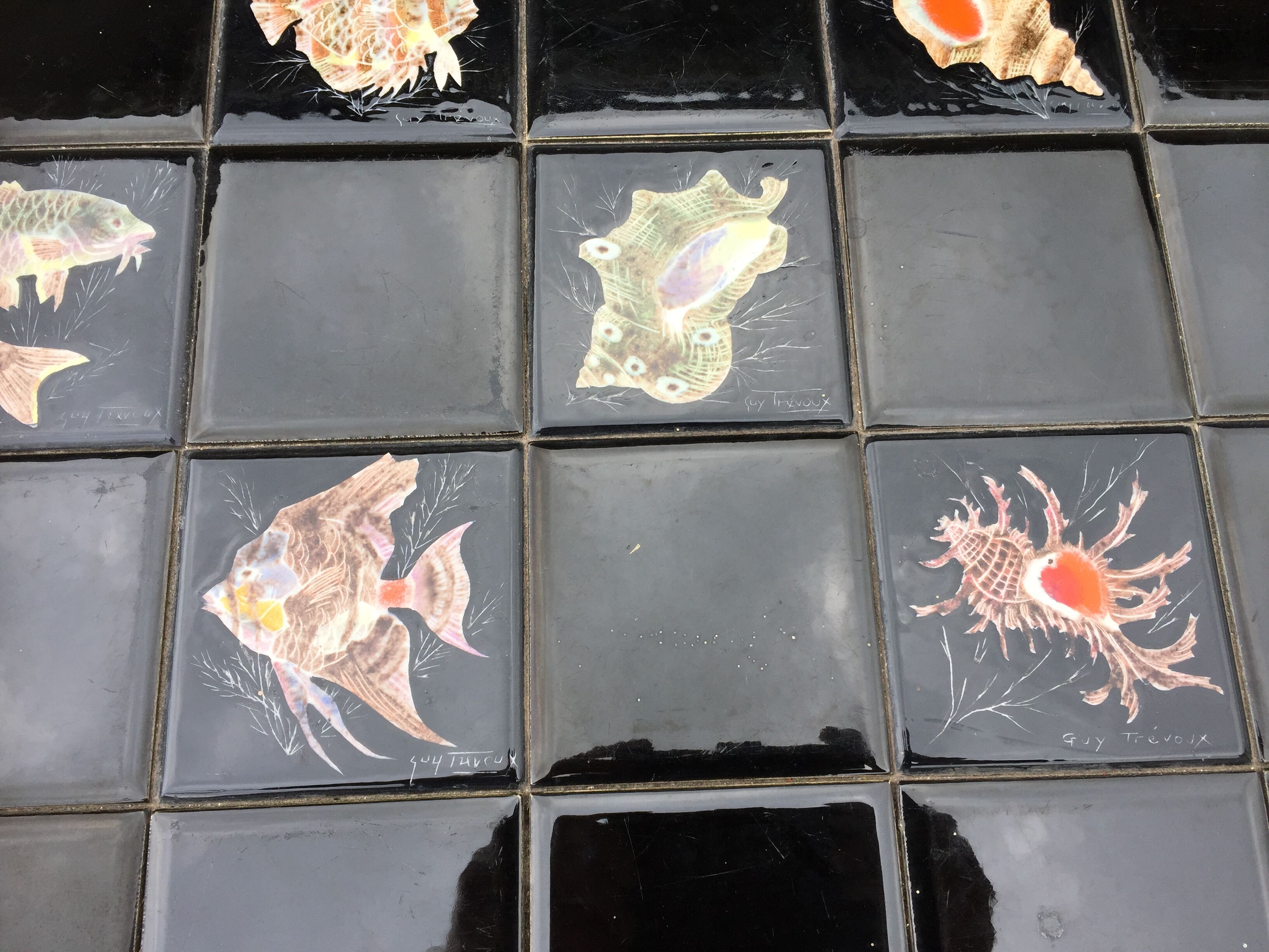 Vintage ceramic coffee table by Guy Trévoux with wrought iron base.