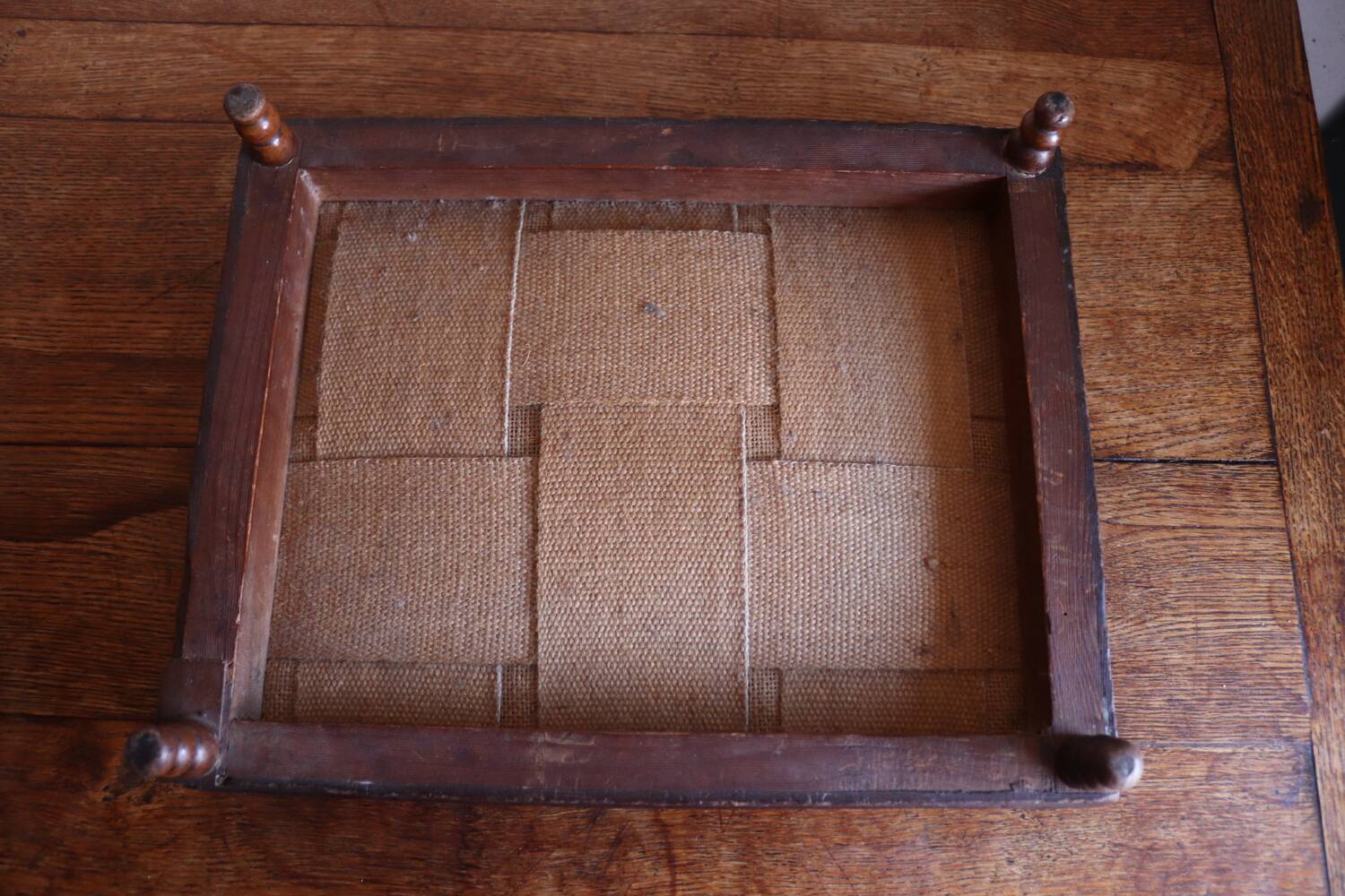Small antique wooden and fabric footrest.