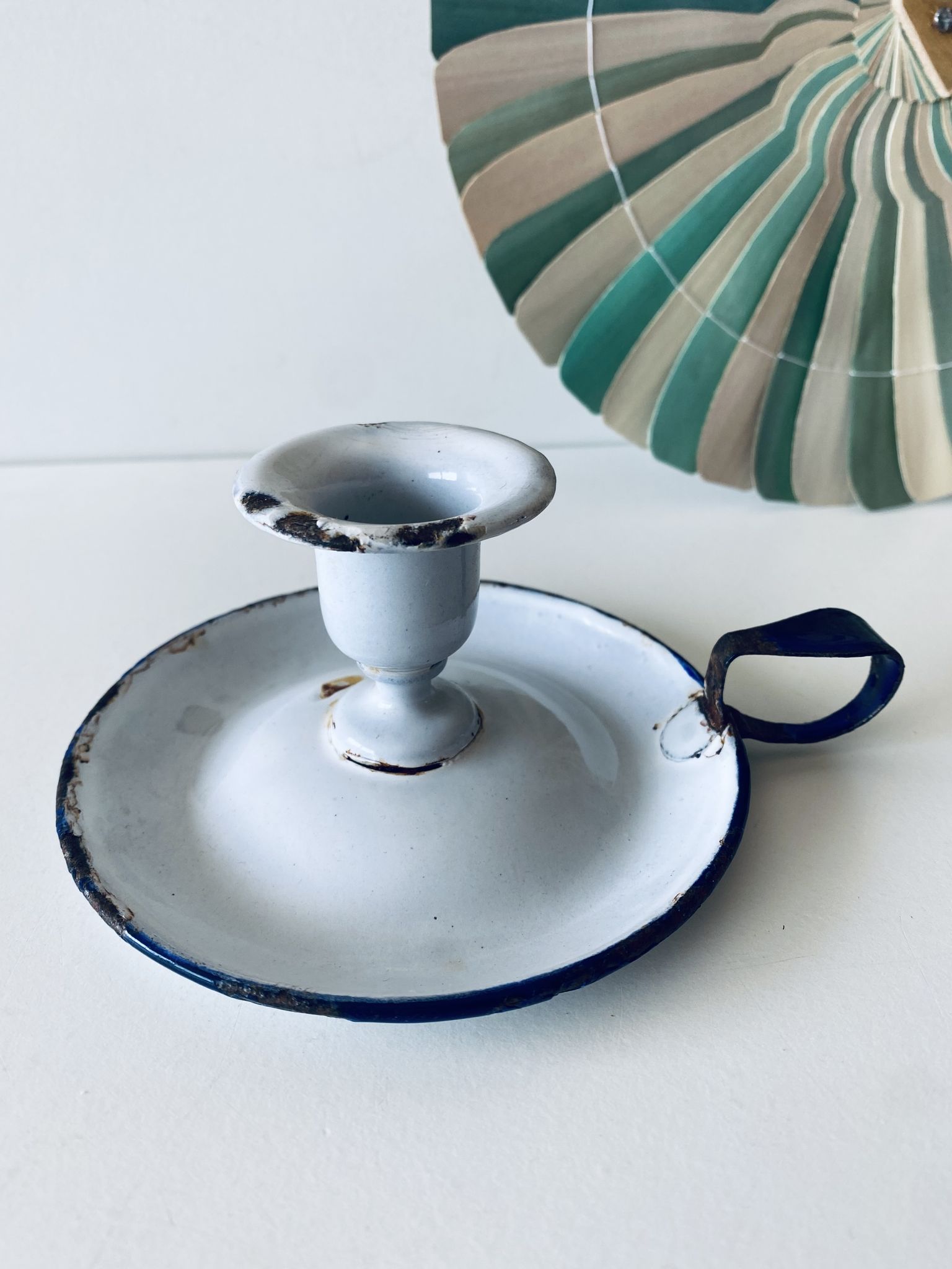 Antique candle holder in white and blue enamelled metal