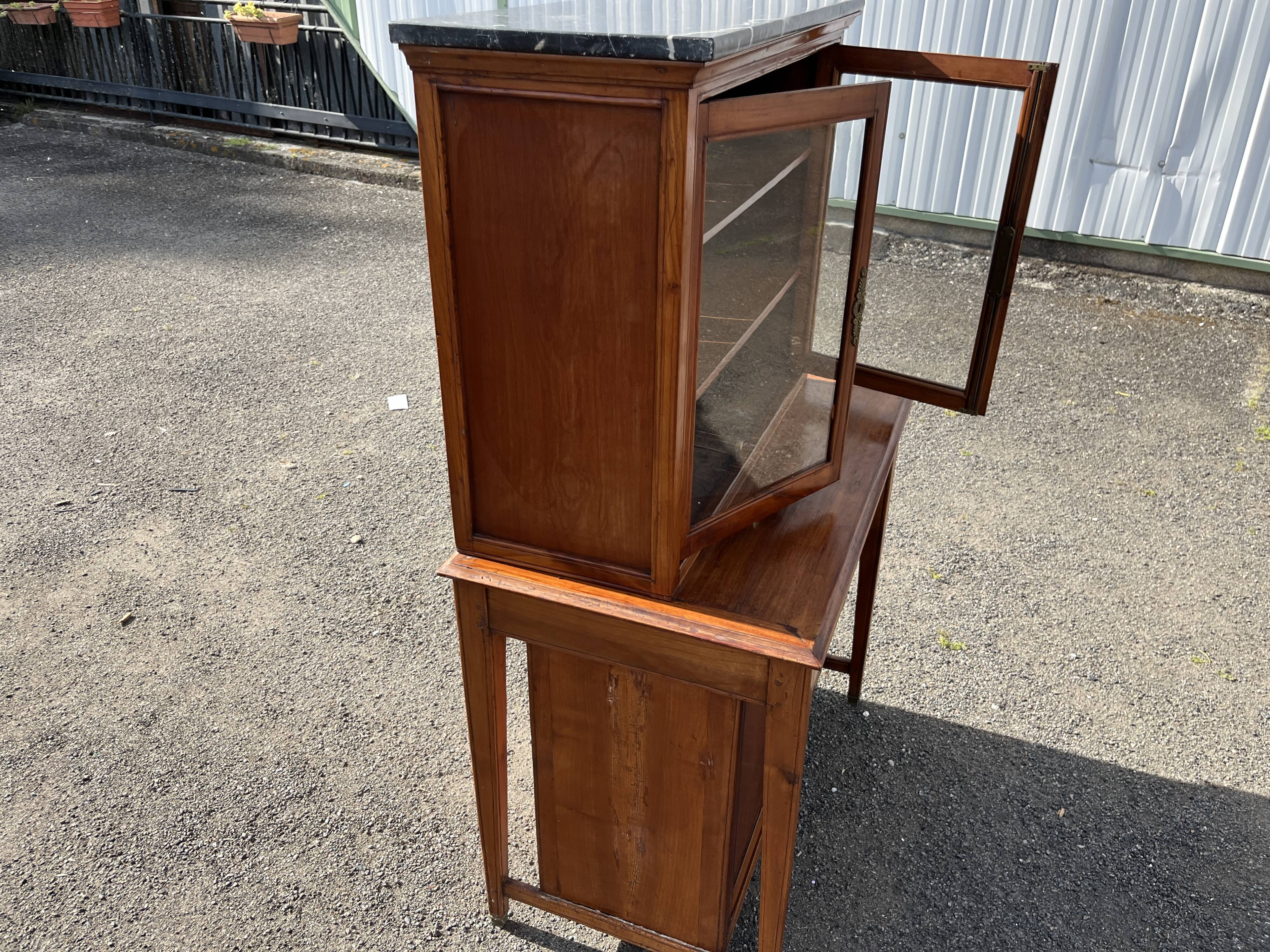 Victorian English two-body buffet with cherry wood on marble display case from the 19th century.