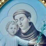 Old religious light frame in gilded stucco and curved glass