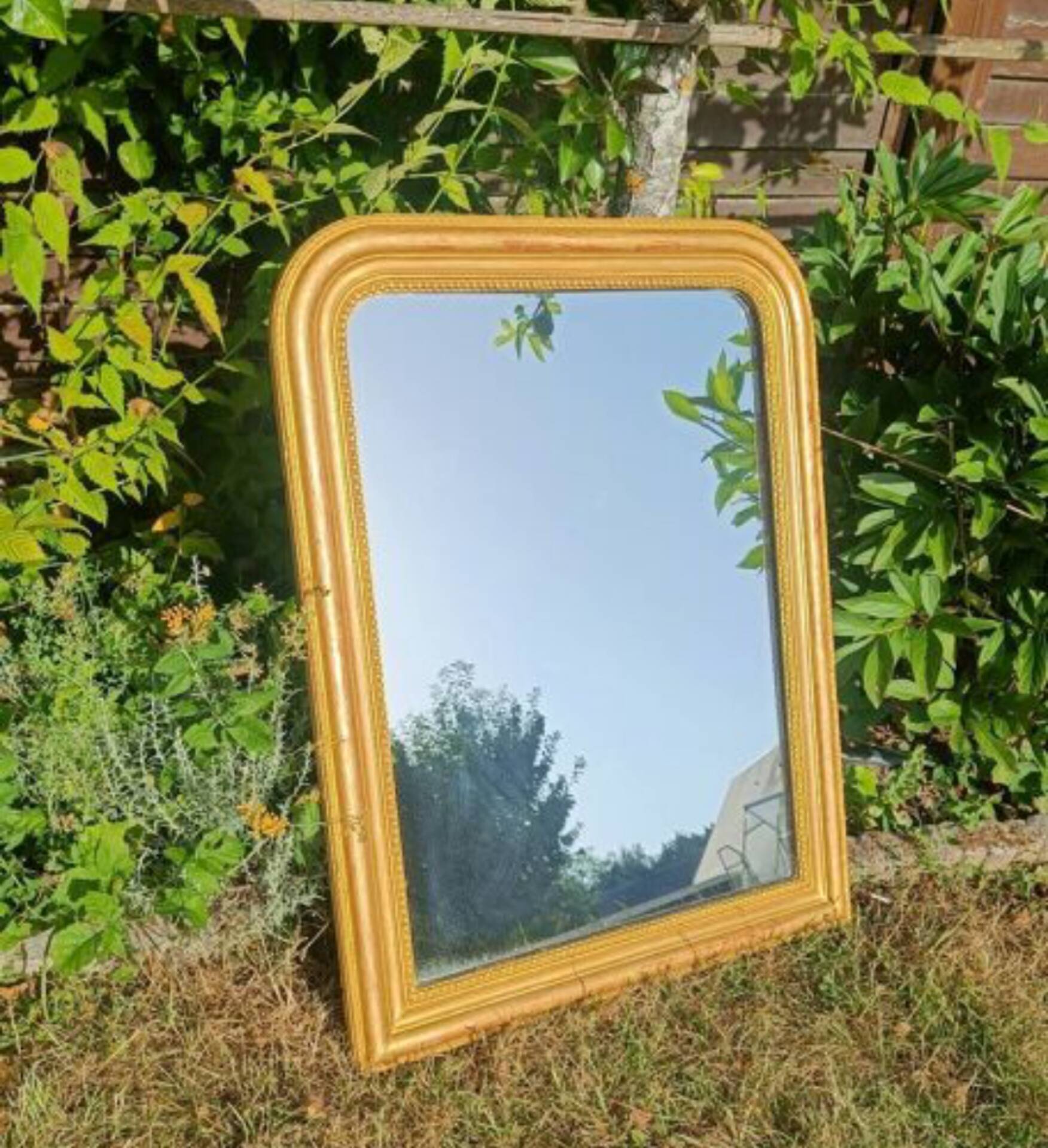 Antique Louis-Philippe mirror, gilded and patinated.