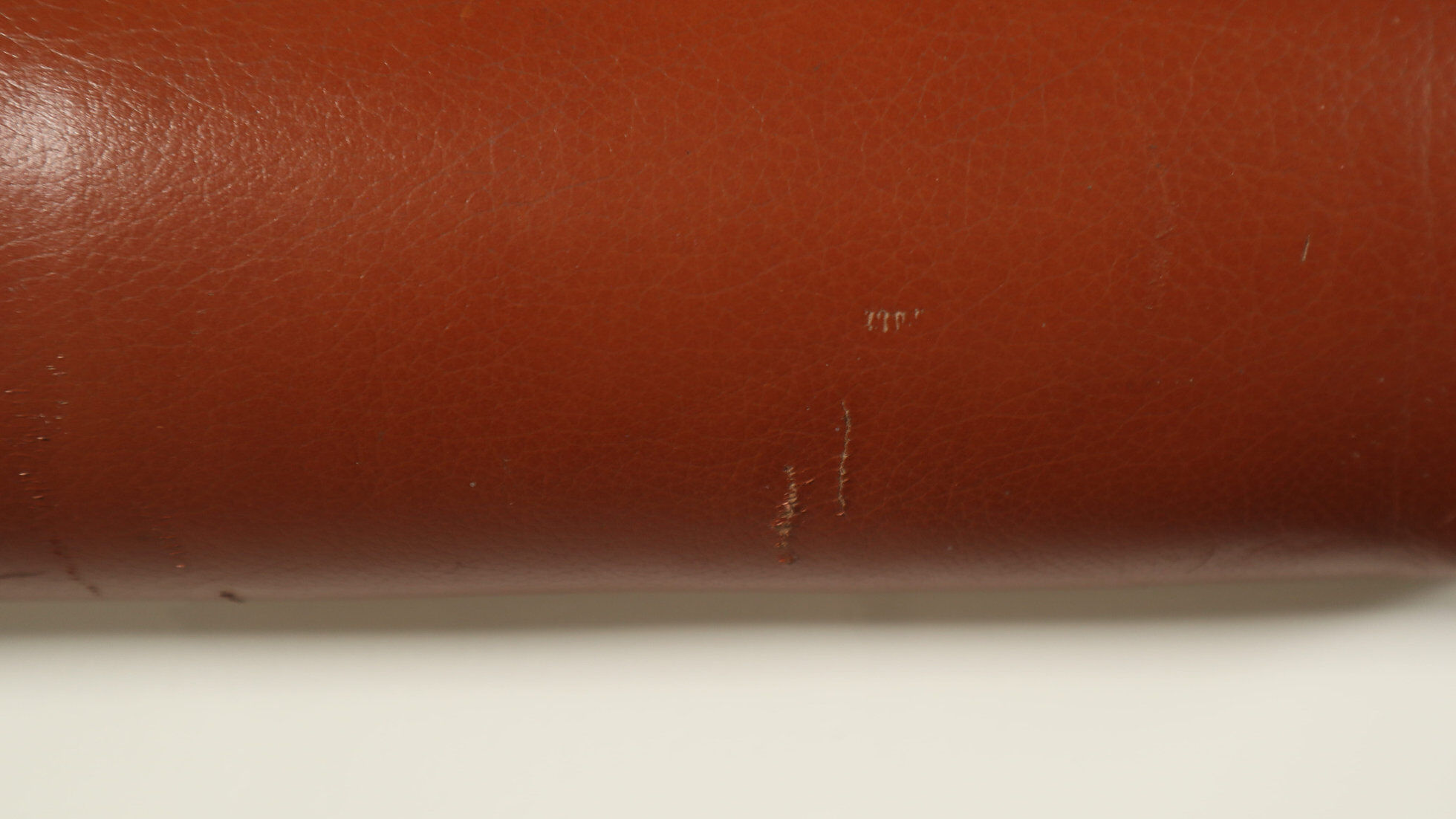 Pair of sculptural cognac leather armchairs, 1970s