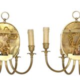 Pair of wall sconces with a relief decoration of a Bacchus mask.