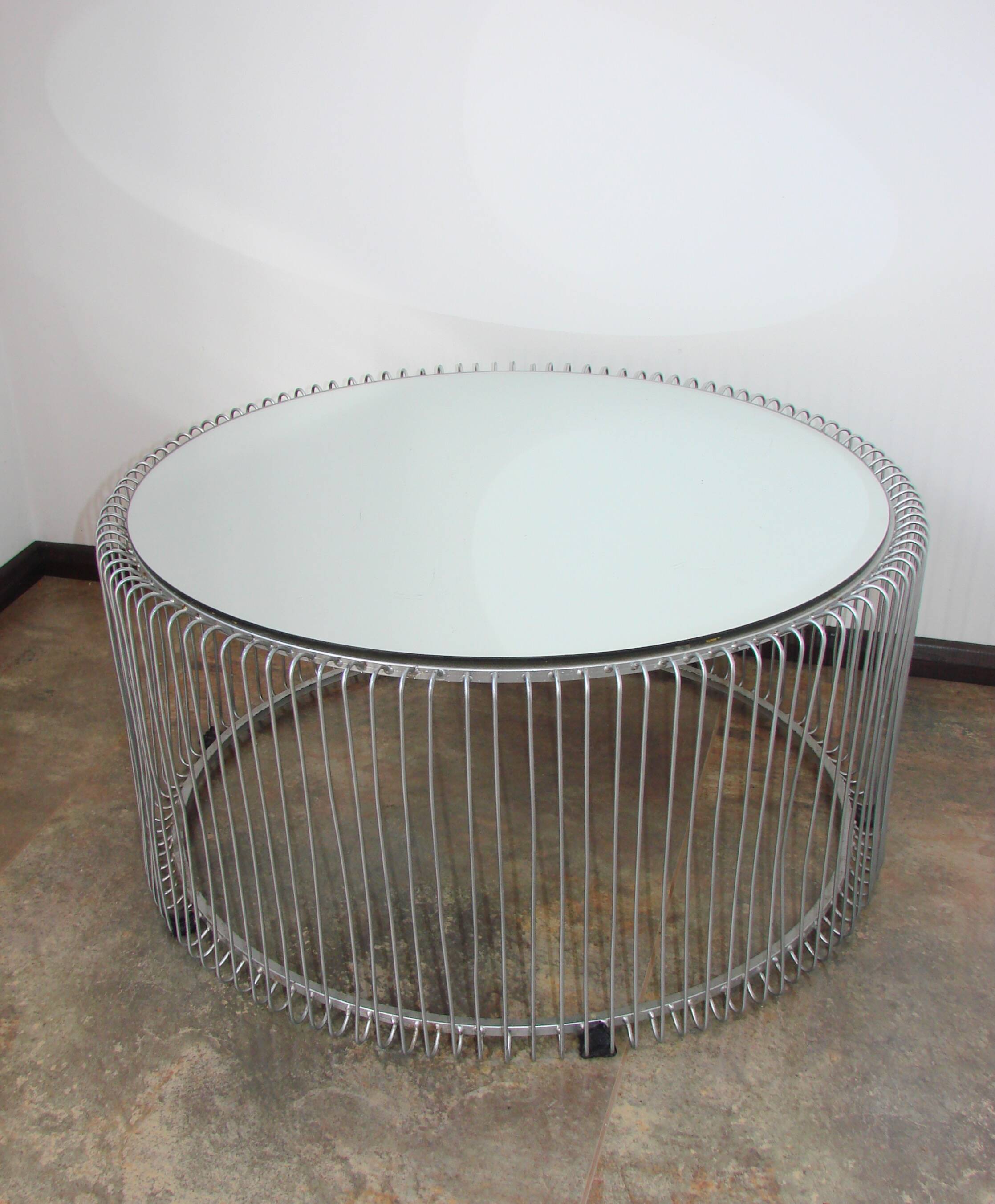 A round coffee table with a mirrored top, from the 1990s.