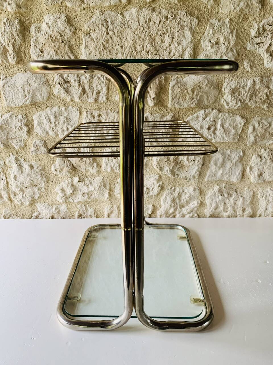 Glass and brass side table with magazine rack, circa 1970's