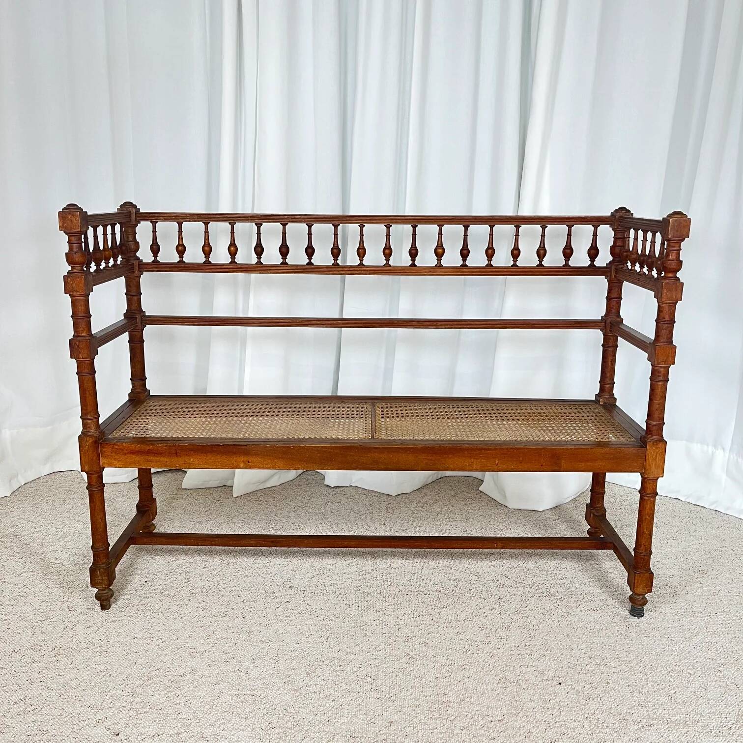 Antique banquette in Louis XIII style, turned wood with caning, late 19th to early 20th century.