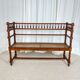 Antique banquette in Louis XIII style, turned wood with caning, late 19th to early 20th century.
